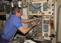 Bill McArthur rehydrates a food packet (NASA)