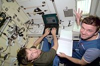 Sergei & Yurii using laptop (NASA)